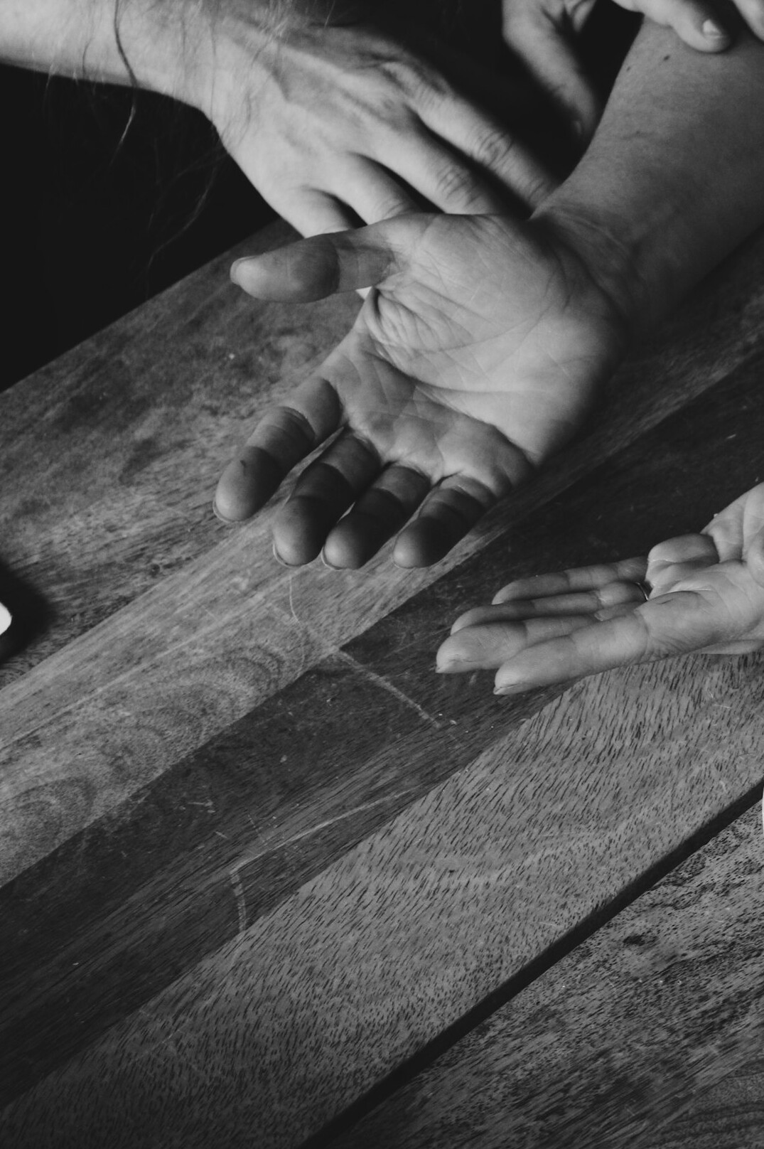 Two professionals shaking hands over a table with design plans