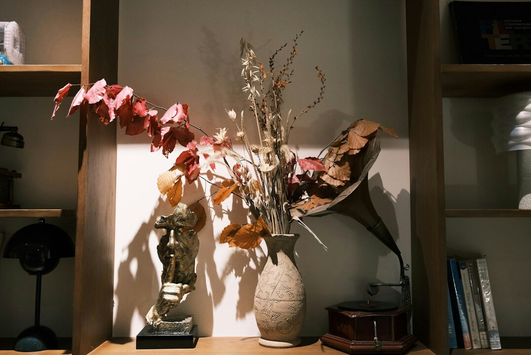 Close-up of a vintage armchair and decorative objects on a shelf